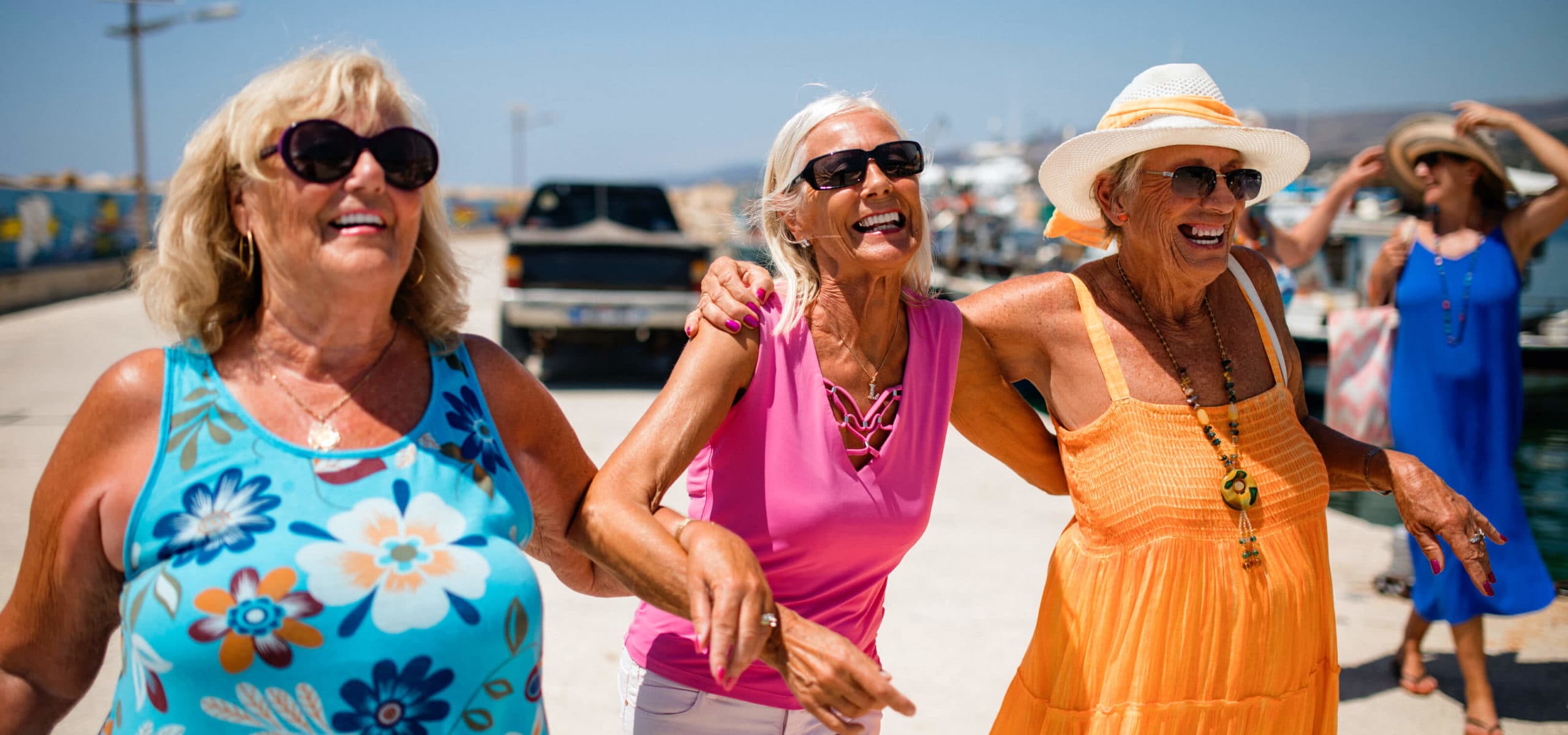 3 Senior Ladies enjoy the sunshine dressed brightly